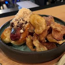 Ardent signature dishes Hand-diced beef tartare with deviled egg mousse and whipped bone marrow, Wagyu beef hot dogs with shaved foie gras.